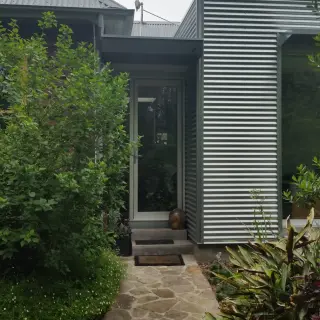 Entrance doors provide a visual break between original fabric and the addition