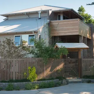 The timber clad balustrade screens adjacent development