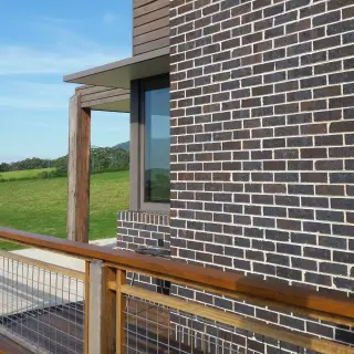 Clear finished decking and balustrade contrasting with the hardwood weatherboards