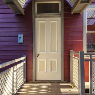 The rolled roof and balustrade are physically separated from the original fabric