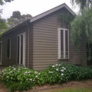 Splayed weatherboards, French doors and double hung windows
