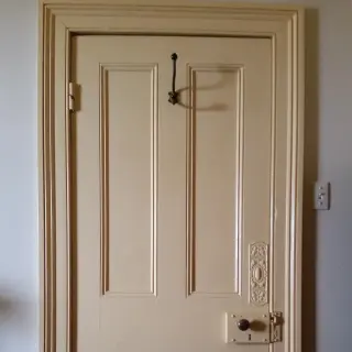 Original architrave, four panel door and door furniture