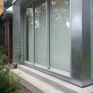 Galvanised steel contrasts with the original hardwood weatherboard wall cladding
